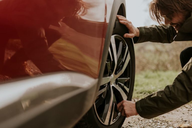 Man checking tyres before car service